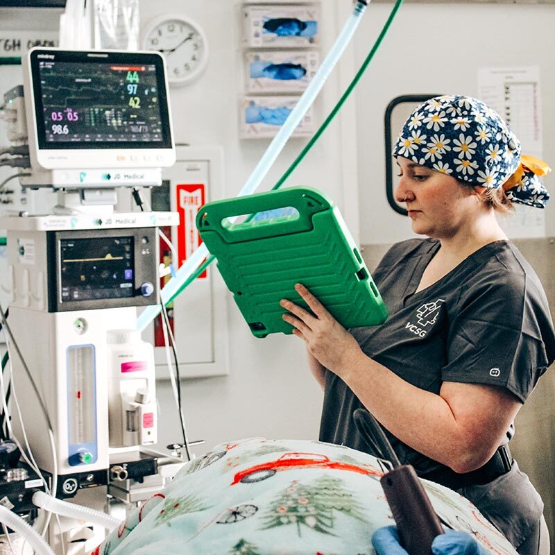 Surgery Safety assistant taking notes and monitoring vitals during surgery